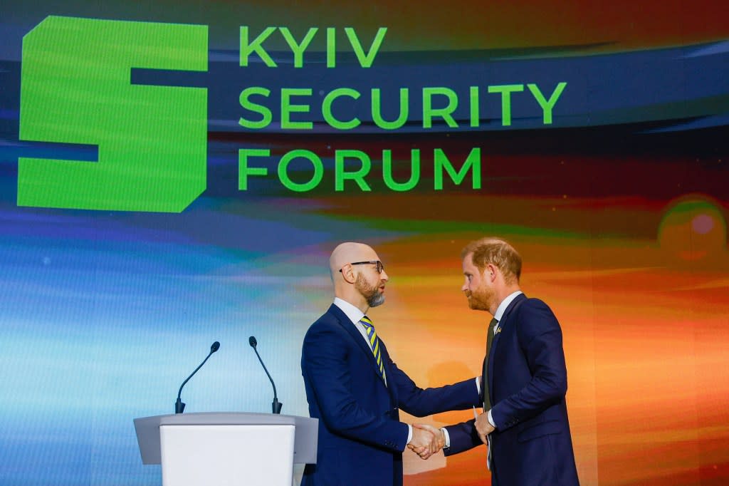 Harry acted like a royal dignitary as he shook hands with Arseniy Yatsenyuk at the Kyiv Security Forum. REUTERS