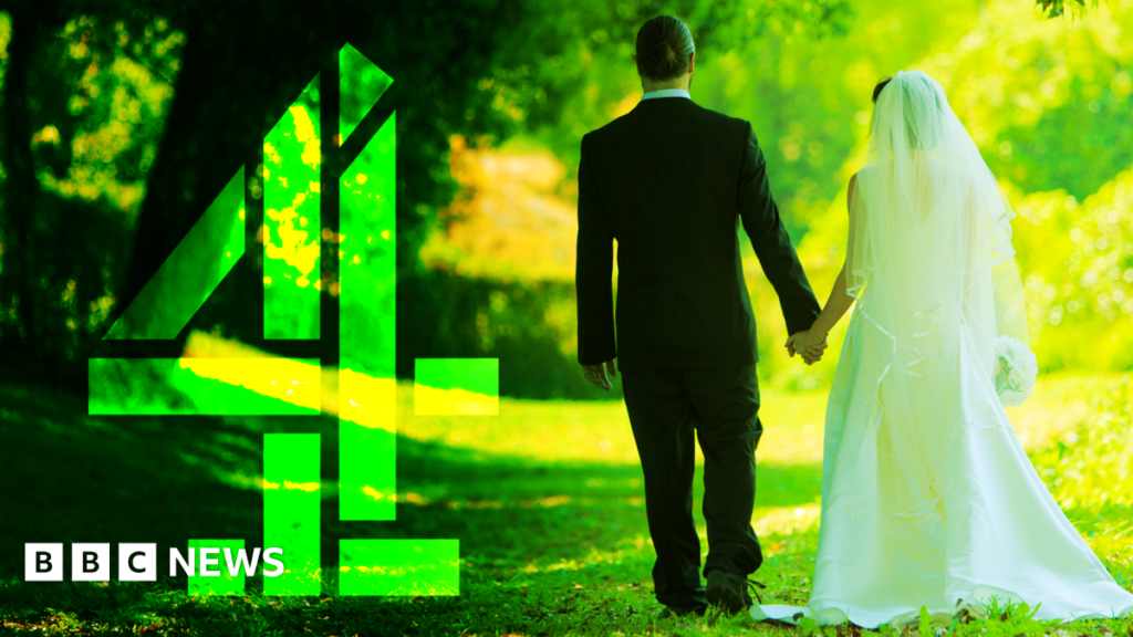 A groom dressed in a dark suit and a bride dressed in white walk hand in hand along a sunlit grassy path, surrounded by tall green trees. Bright sunlight filters through the leaves. A large green Channel 4 logo sits to the left.