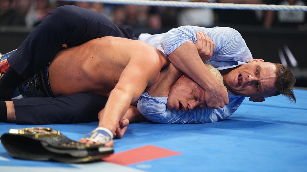 Gunther attacking Cody Rhodes in a wrestling ring at Rupp Arena