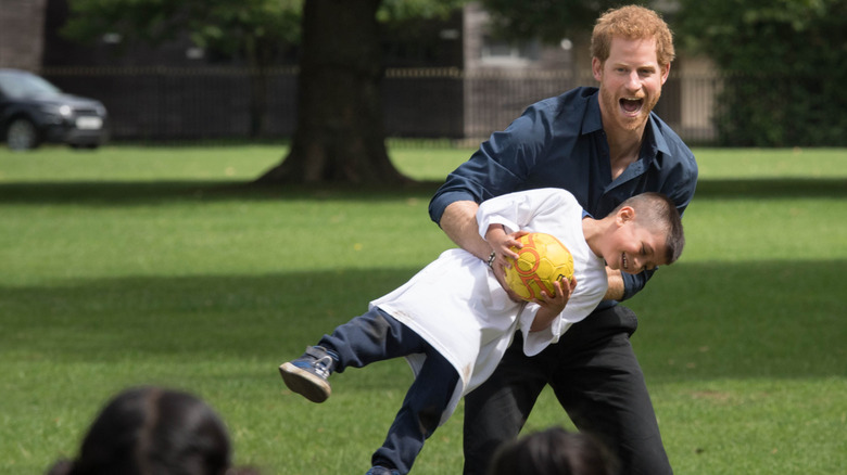 Prince Harry plays with children during a visit to StreetGames' Fit and Fed at Central Park East Ham on July 28, 2017 in London, England.
