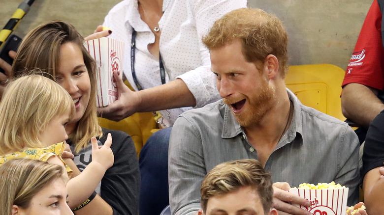 Prince Harry (R) sits with David Henson's wife Hayley Henson (L) and daugther Emily Henson at the Sitting Volleyball Finals during the Invictus Games 2017 at Mattamy Athletic Centre on September 27, 2017 in Toronto, Canada.
