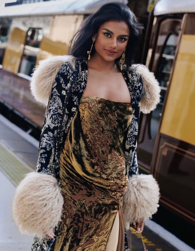 Simone Ashley in archival Donna Karan Fall/Winter 2001 earrings by Dolce & Gabbana for launch of a new private dining carriage for the Belmond British Pullman train