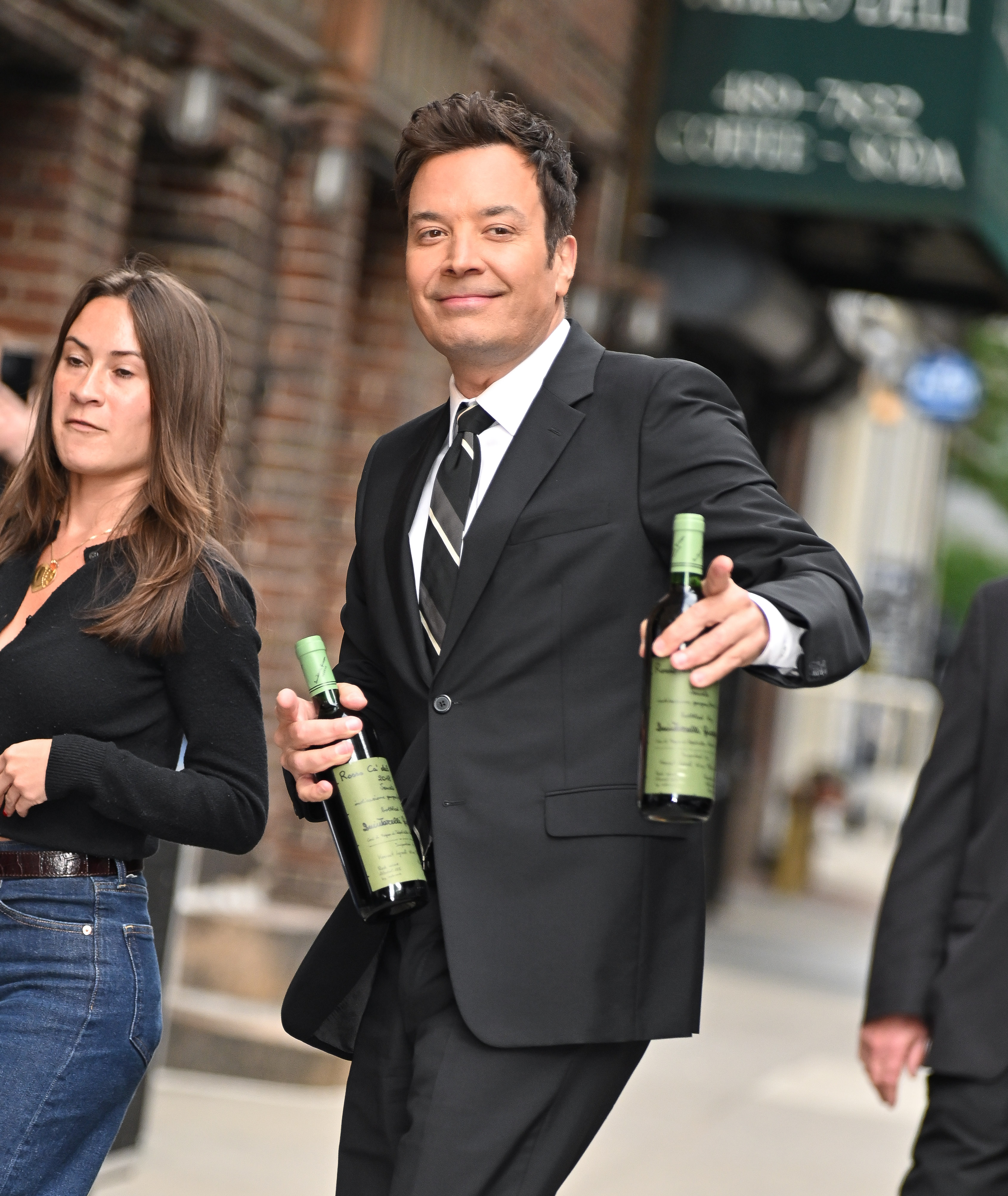 Jimmy Fallon has his hands full while arriving to "The Late Show With Stephen Colbert" at the Ed Sullivan Theater in NYC.