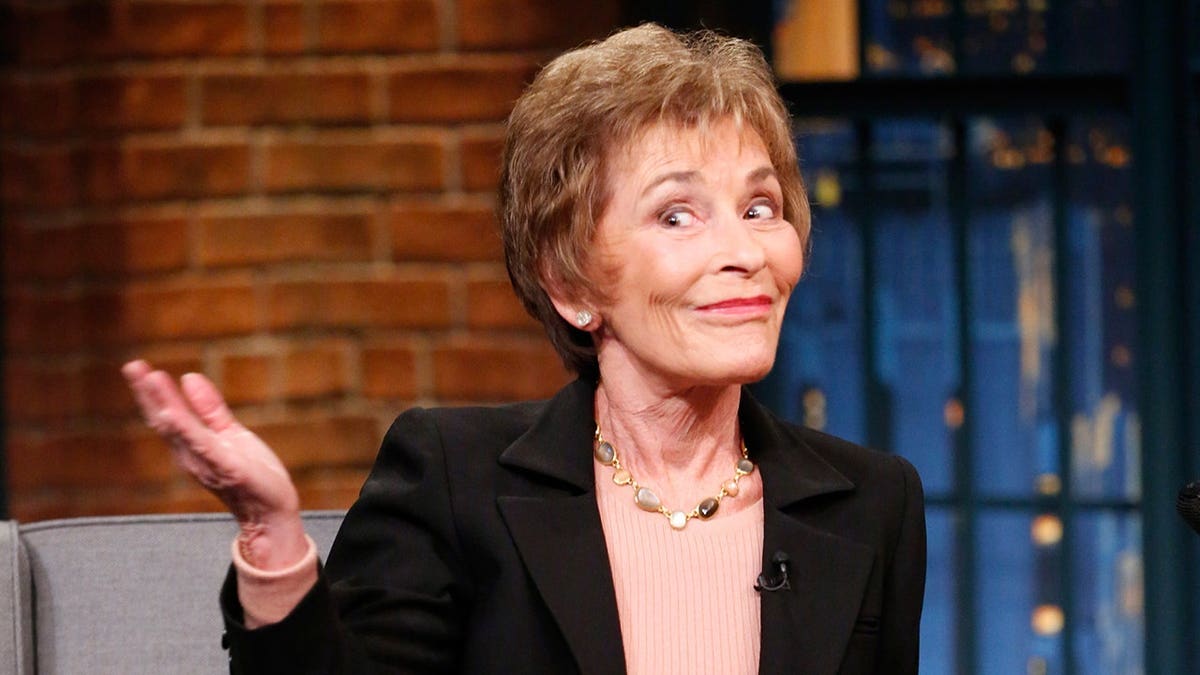 Judge Judy Sheindlin sitting during an interview on a television set
