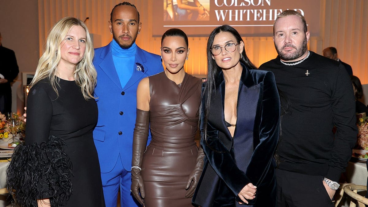 Kim Kardashian with Lewis Hamilton and others at the WSJ. Magazine Innovators Awards in November 2021