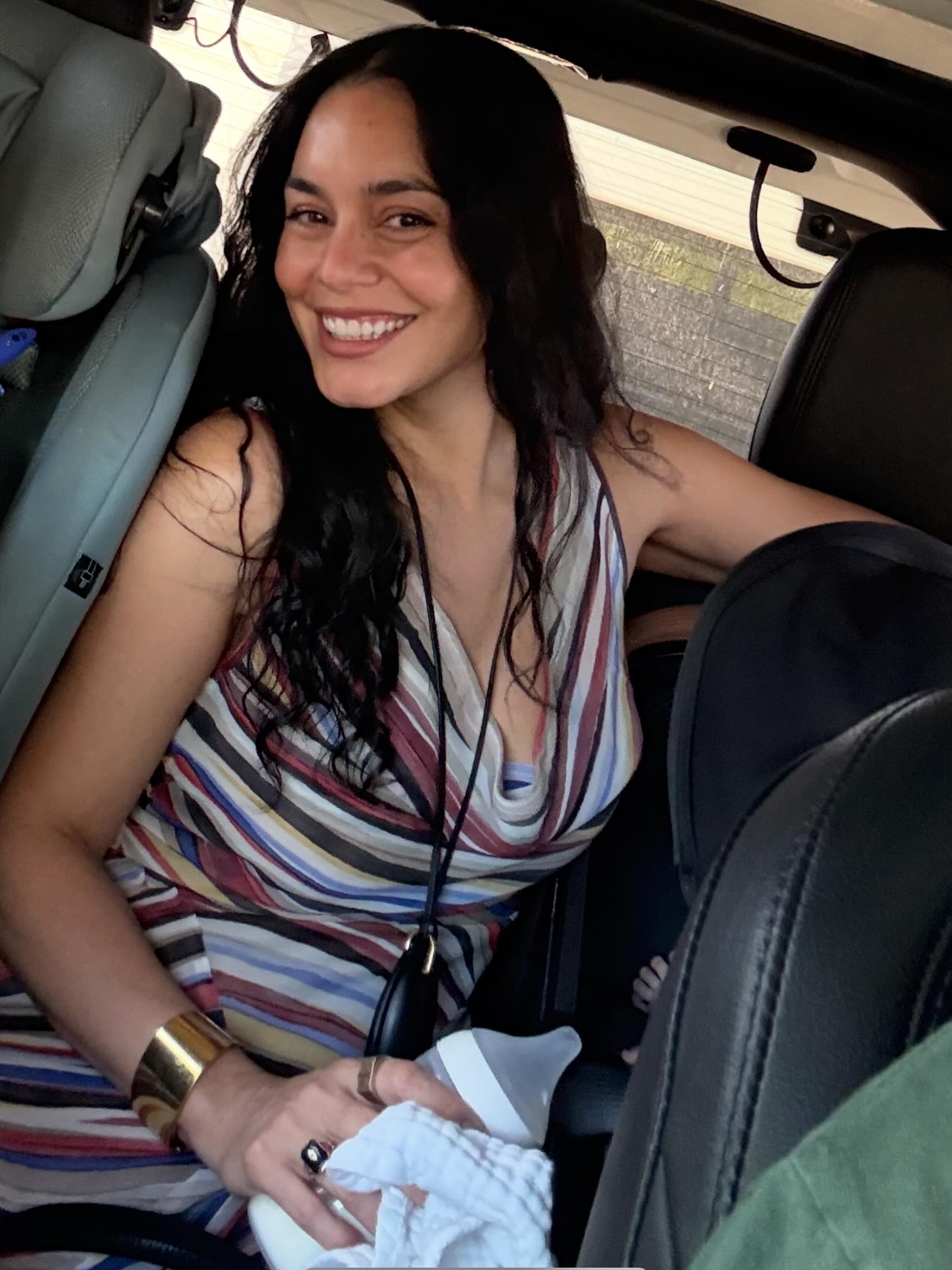 Vanessa Hudgens is "just a mom sandwiched between two car seats trying to give baby a bottle."