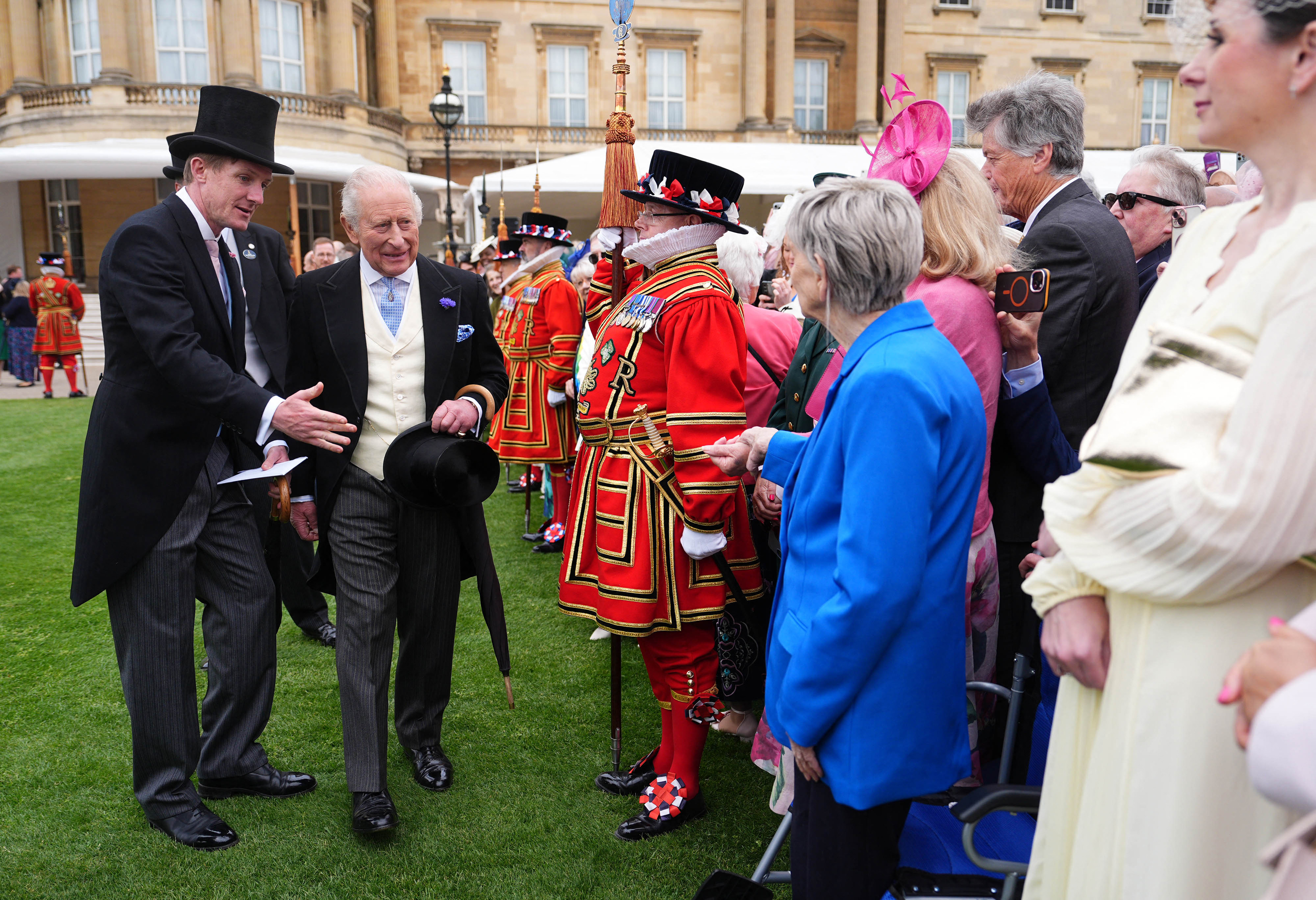 Britain's King Charles III meets Barbara Keel during a Royal Garden Party at Buckingham Palace, in London, on May 6, 2026. (Photo by Aaron Chown / POOL / AFP)