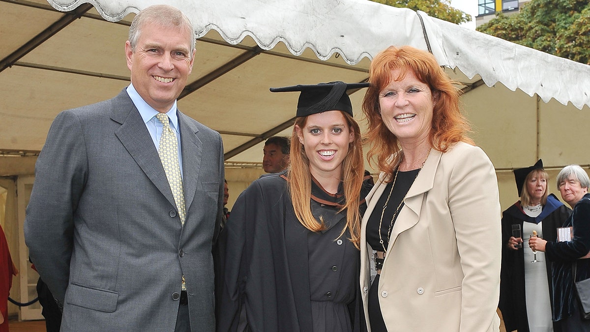 Prince Andrew, Sarah Ferguson, and Princess Beatrice standing together at a graduation ceremony.