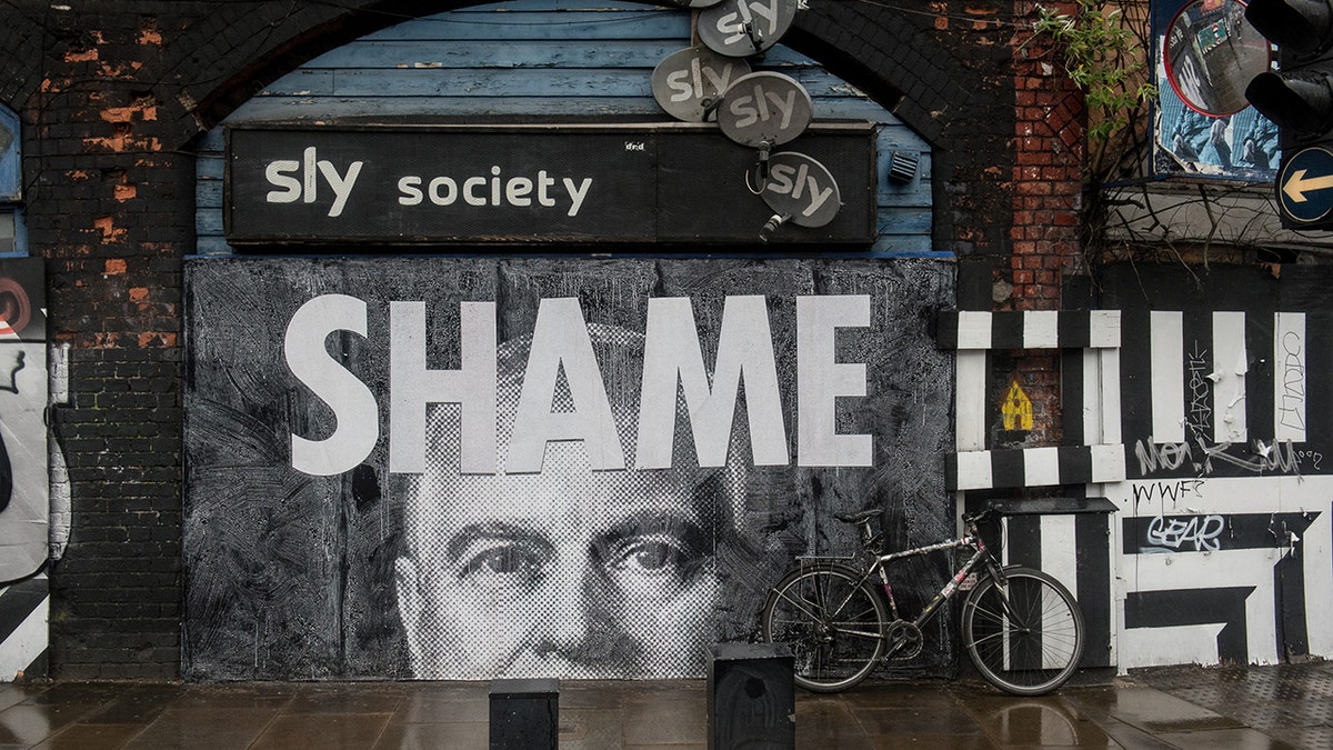 Mural of Prince Andrew with a sign reading Shame in Shoreditch London