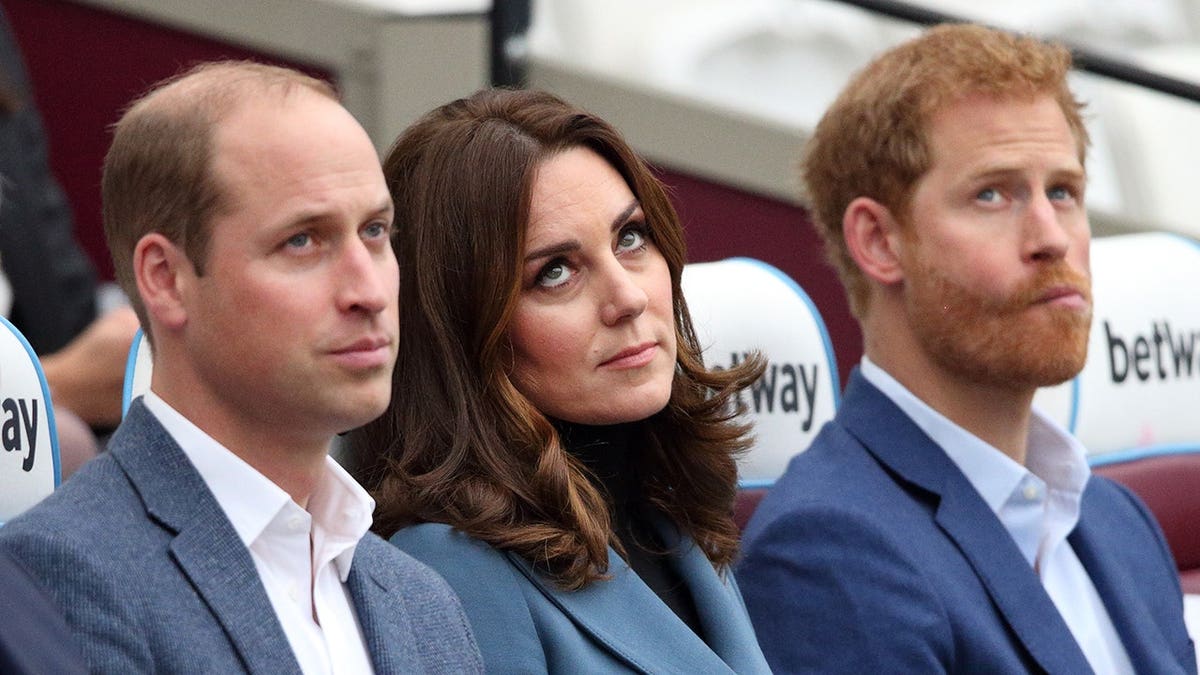 Prince William, Duchess of Cambridge, and Prince Harry standing together at London Stadium