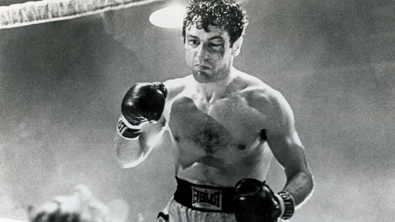 Jake LaMotta standing over a defeated boxer in the ring in 