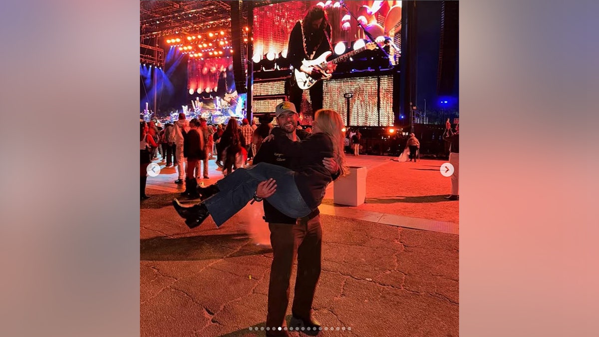 Scooter Braun carrying Sydney Sweeney in front of the stage at Stagecoach in April 2026.