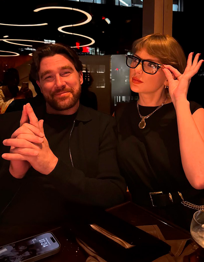 Taylor Swift with partner posing at dinner amid wedding guest drama