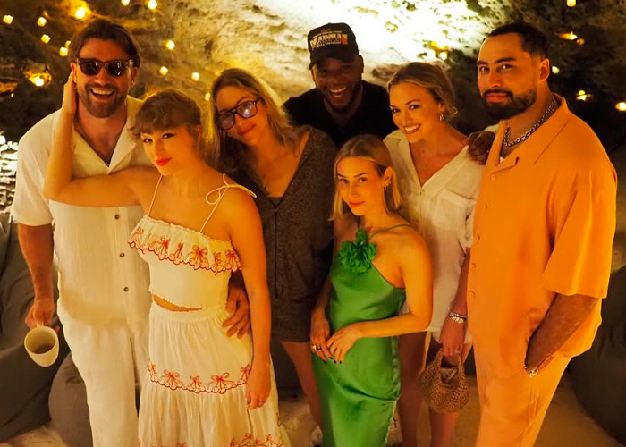 Group photo of Taylor Swift and friends at an evening gathering