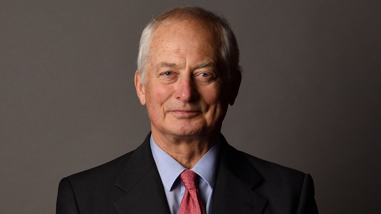 A headshot of Prince Hans-Adam II against a gray backdrop