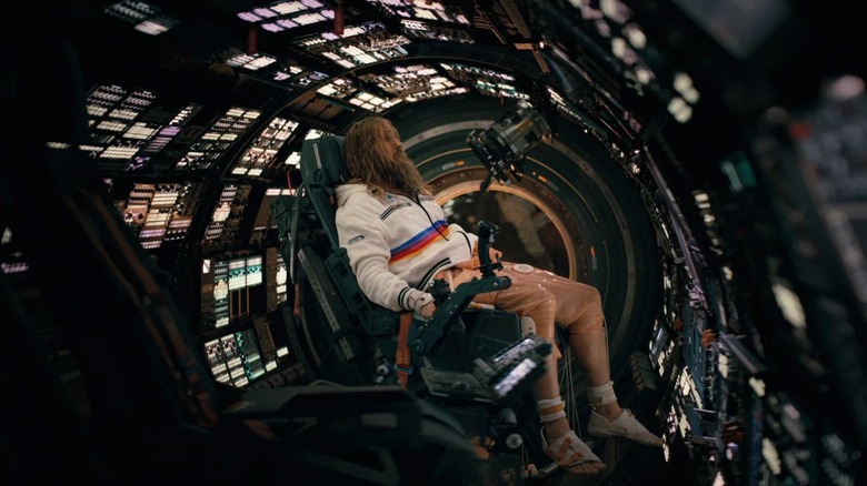 Dr. Ryland Grace with long hair and a beard in a spacecraft cockpit in Project Hail Mary