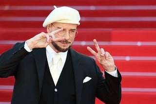 John Travolta and his beret visit Cannes