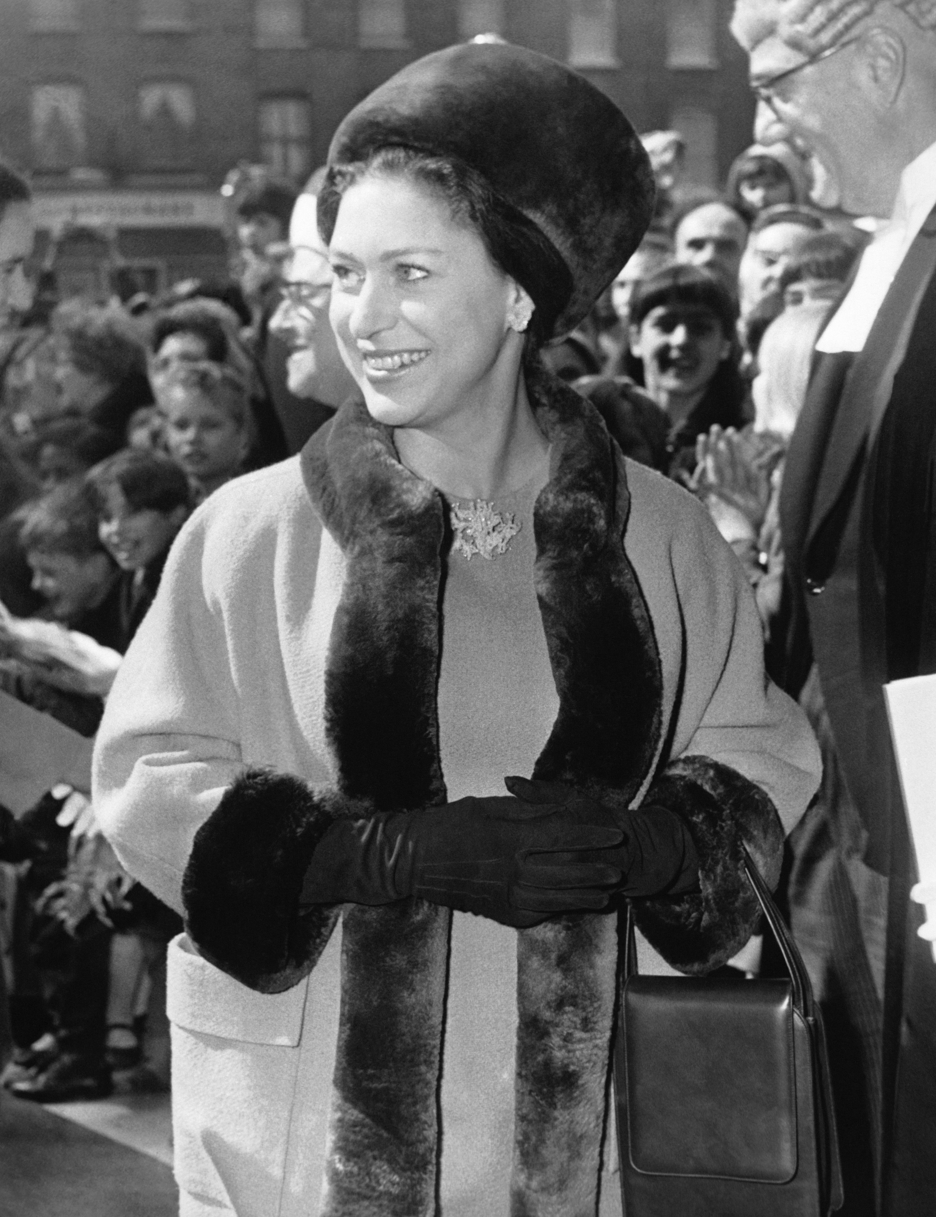 Princess Margaret wearing a fur trimmed coat and hat