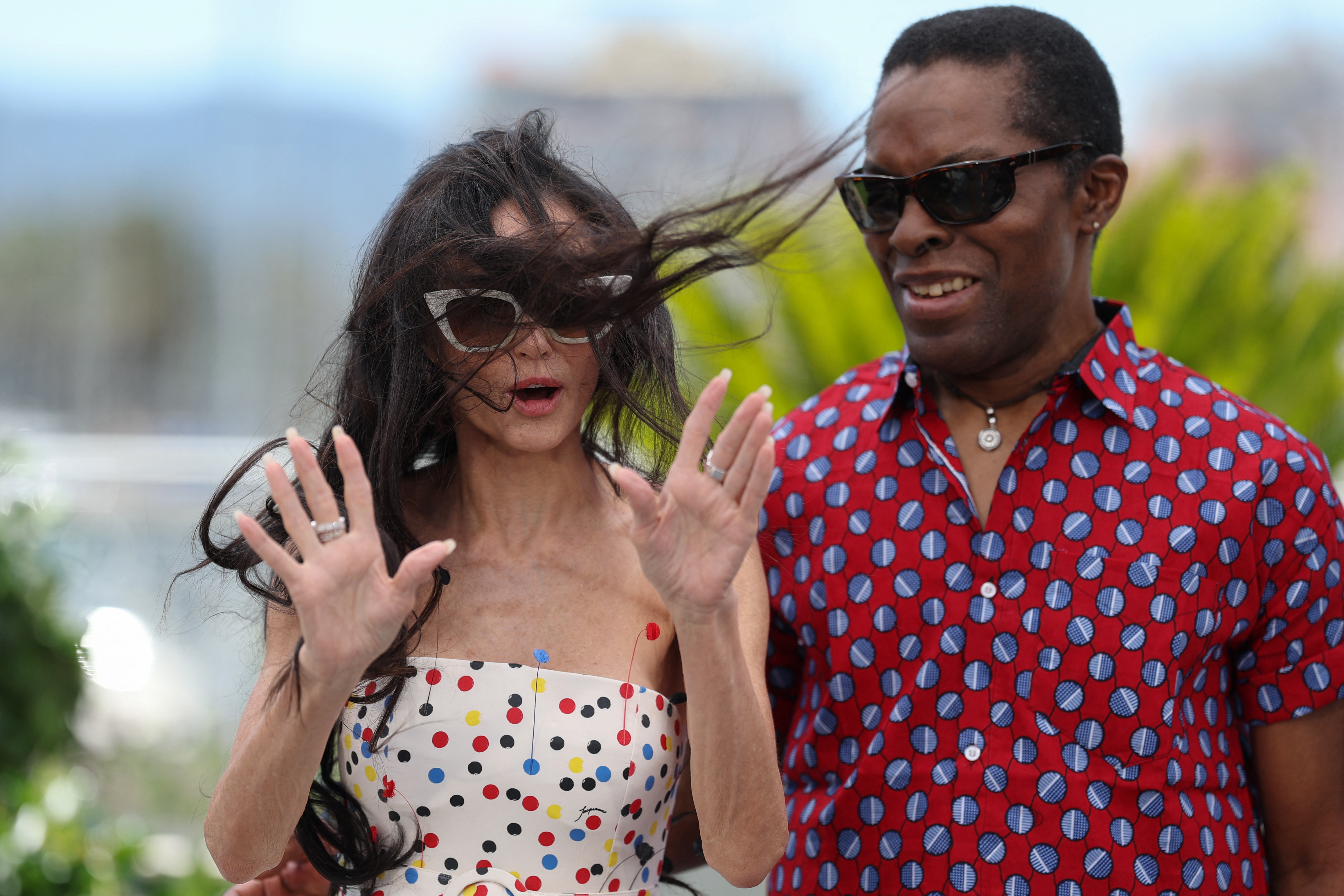 Demi Moore battles with the wind while she attends a photocall of the members of the jury with Isaach De Bankole at the 79th edition of the Cannes Film Festival in Cannes, France.