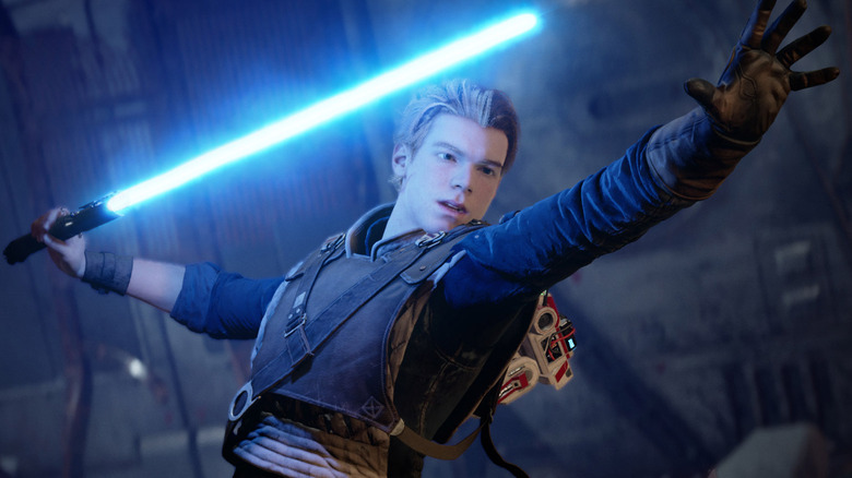 Cal Kestis with his blue lightsaber in one hand in Star Wars Jedi: Fallen Order