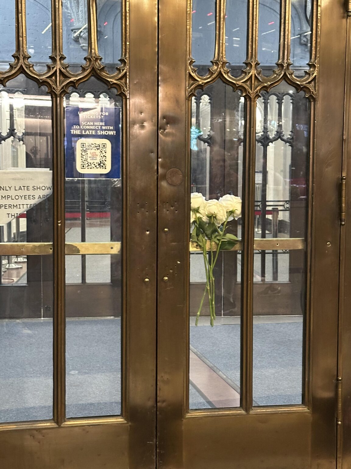 Flowers left on the door of the Ed Sullivan theatre yesterday where The Late Show With Stephen Colbert is taped