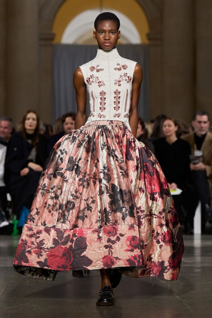 Erdem Fall 2026 runway look featuring floral embellishments and a voluminous printed skirt.