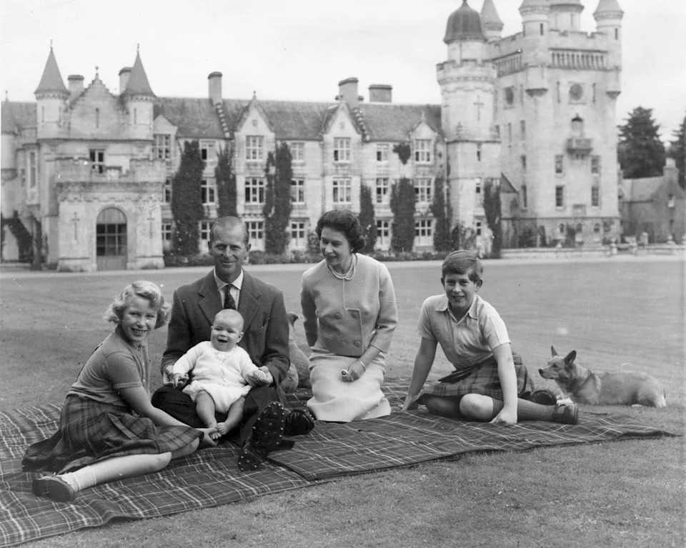The Royal Family sitting on a blanket in front of Balmoral Castle in 1960