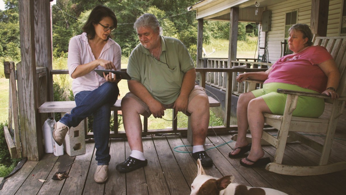 woman sits on porch with elderly couple in Alabama for documentary project America's 250