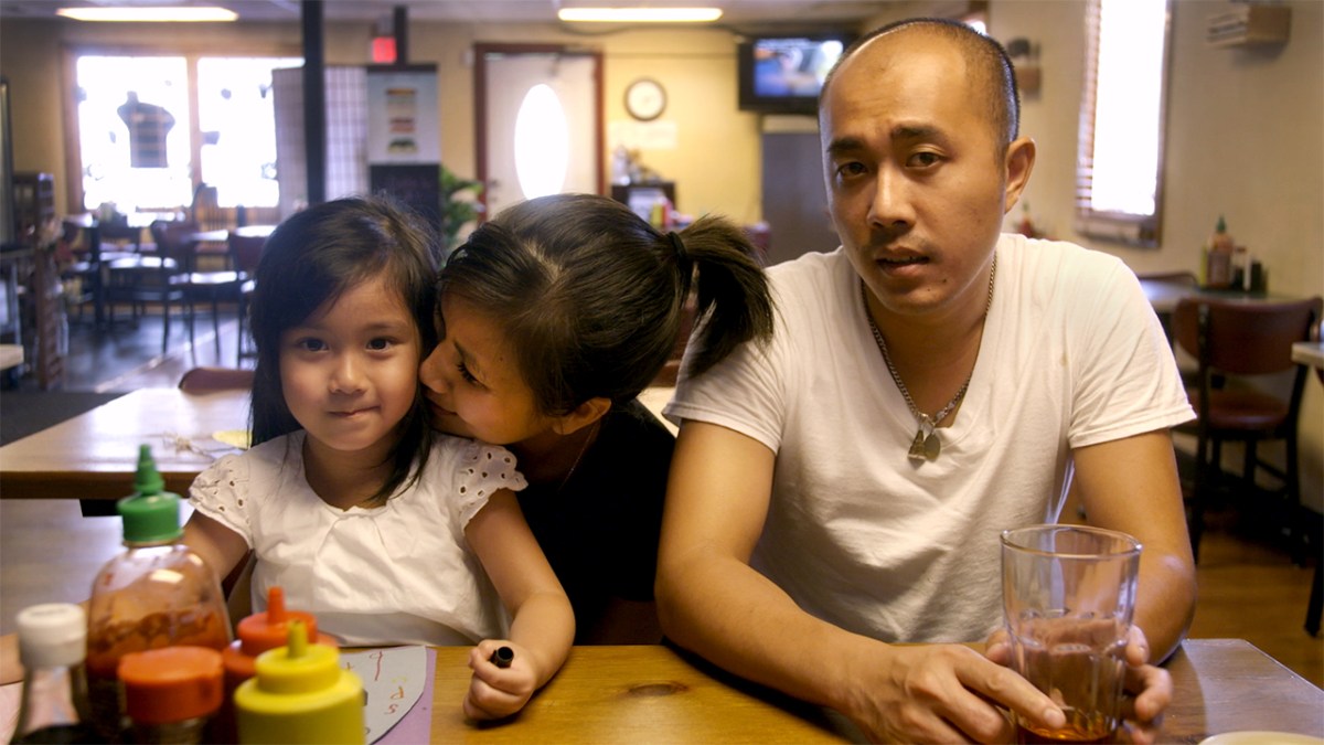 family at a table waiting to be interviewed for Whitman, Alabama documentary