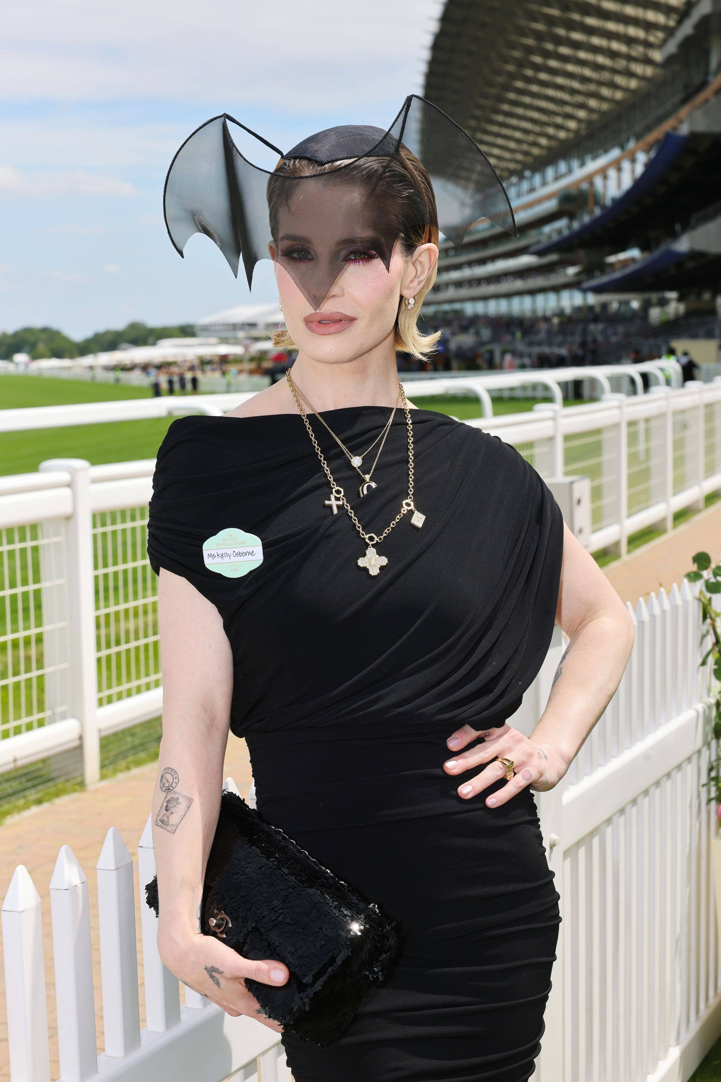 Kelly Osbourne in black dress with bat hat