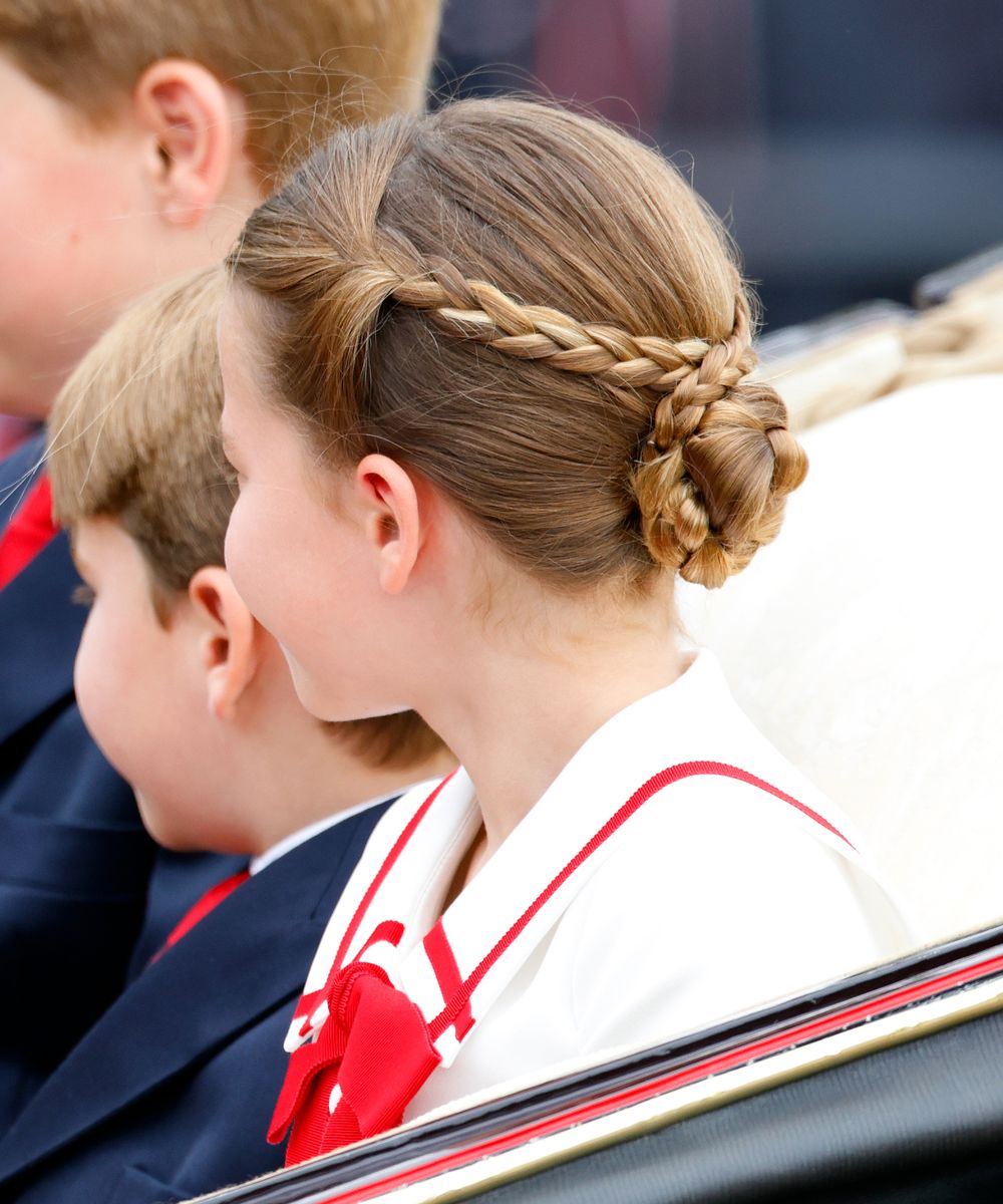 Princess Charlotte's hairstyle at Trooping the Colour 2022 featured two delicate side braids tied with a blue ribbon, a look reminiscent of the romantic beauty associated with Empress Sissi.