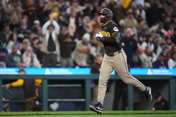 San Diego Padres' Nick Castellanos jogs home after hitting a three-run home run against the Seattle Mariners during the fourth inning of a baseball game, Saturday, May 16, 2026, in Seattle. (AP Photo/Lindsey Wasson)