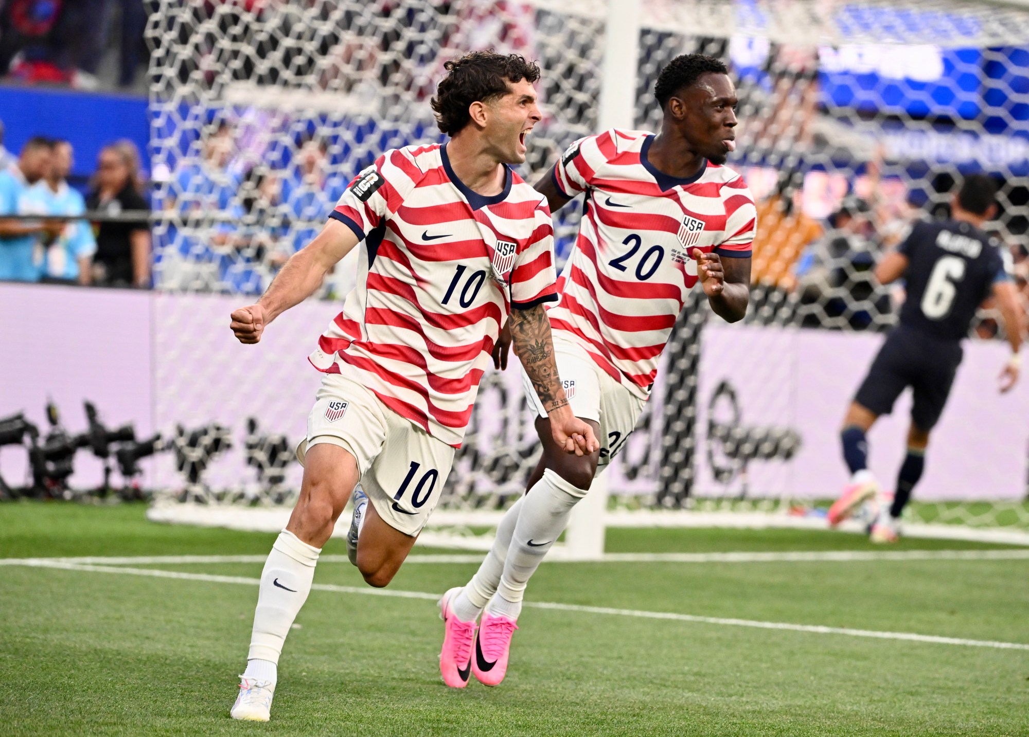 United States midfielder Christian Pulisic, left, and forward Folarin Balogun...