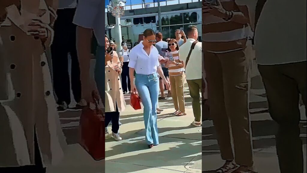 Jennifer Lopez turns heads as she steps out in a chic white shirt and blue jeans! ✨👖❤️