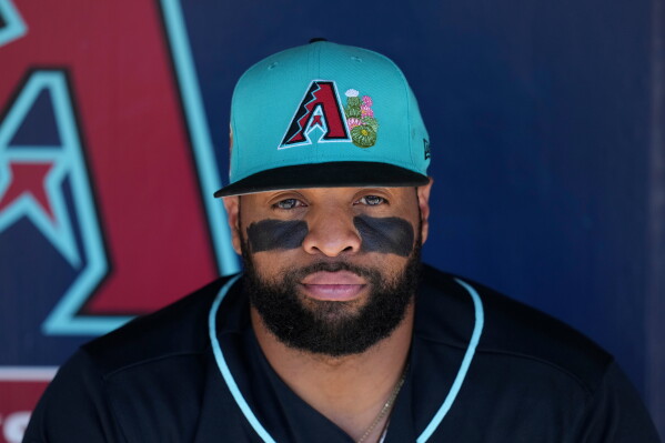 Arizona Diamondbacks' Carlos Santana sits in the team dugout prior to a spring training baseball game against the Kansas City Royals Thursday, Feb. 26, 2026, in Scottsdale, Ariz. (AP Photo/Ross D. Franklin,File)