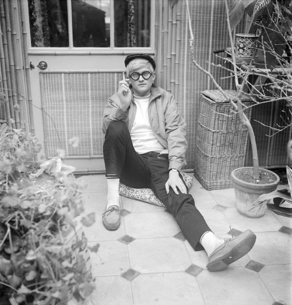 Black-and-white image of David Hockney smoking