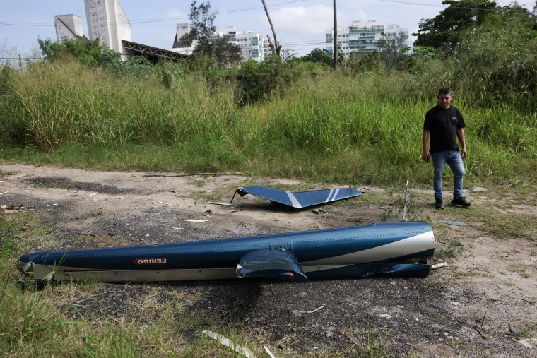 Parts of a helicopter lie on the ground following a collision between two helicopters in Rio de Janeiro