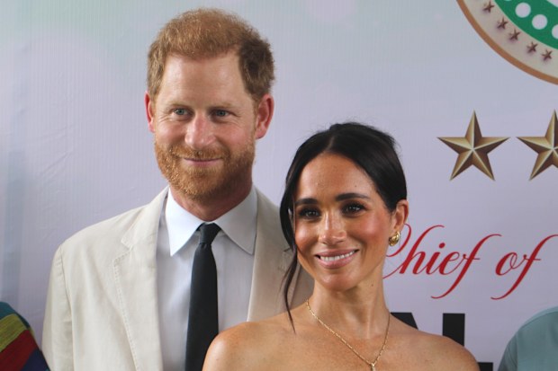 Britain's Prince Harry, Duke of Sussex, and Britain's Meghan, Duchess of Sussex, pose for a photo as they attend the program held in the Armed Forces Complex in Abuja, Nigeria on May 11, 2024.