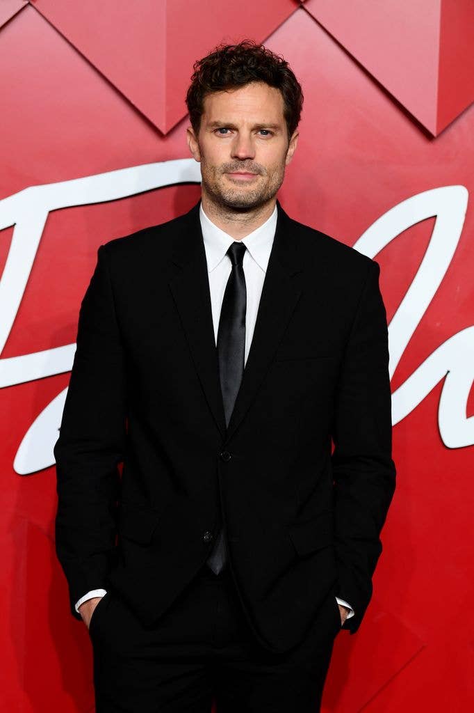 Jamie Dornan in a black suit and tie
