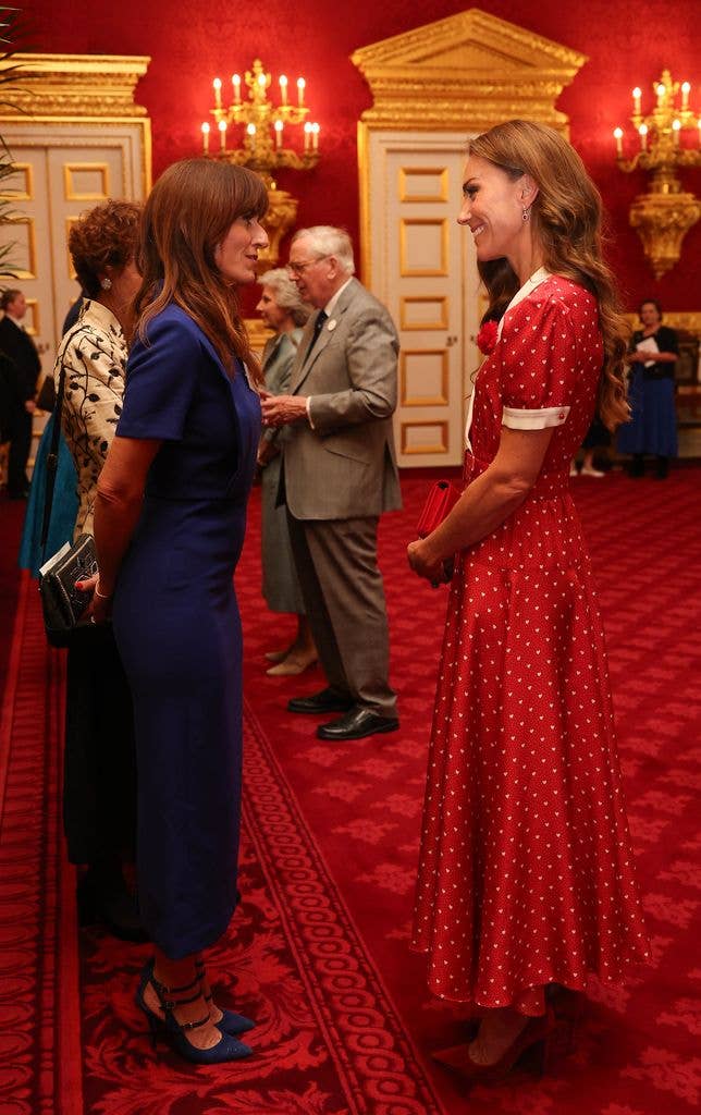 Davina McCall in a blue dress chatting to Princess Kate