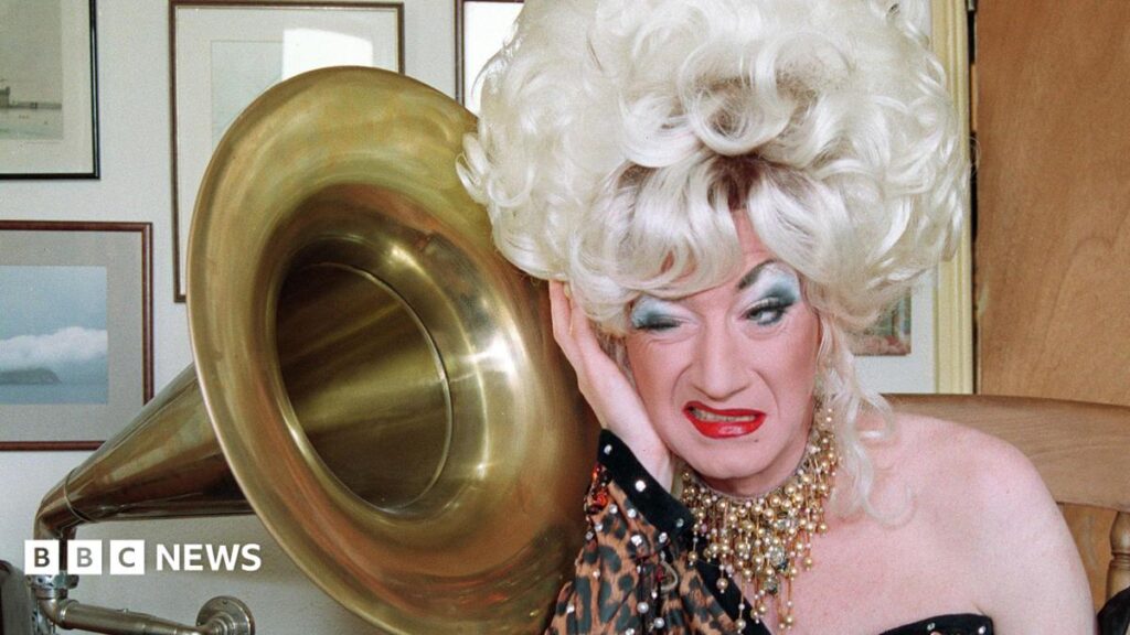 Paul O’Grady life story show set for national tour Paul O'Grady as his alter ego Lily Savage in a blonde wig next to a grammarphone