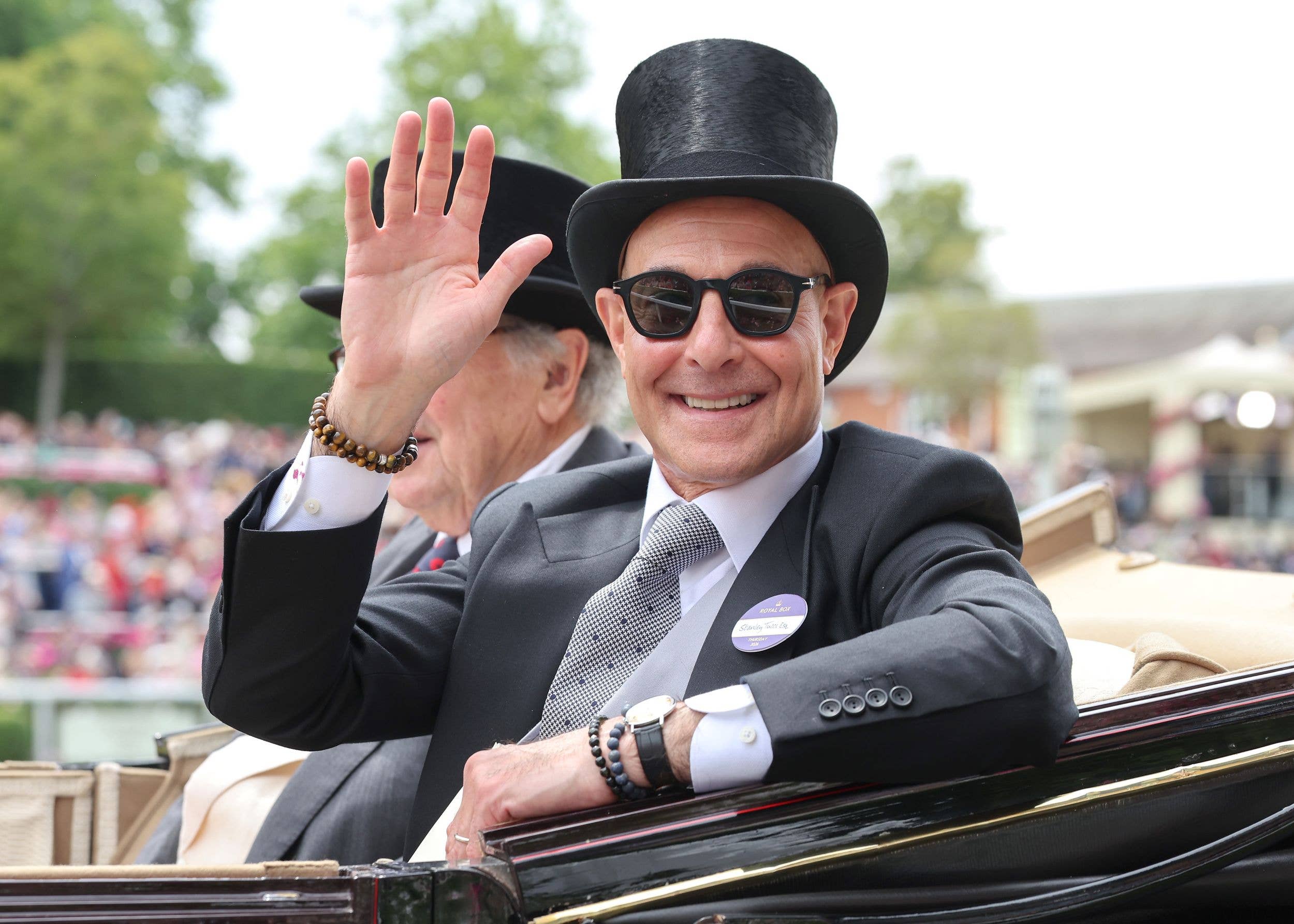 stanely tucci waving from carriage
