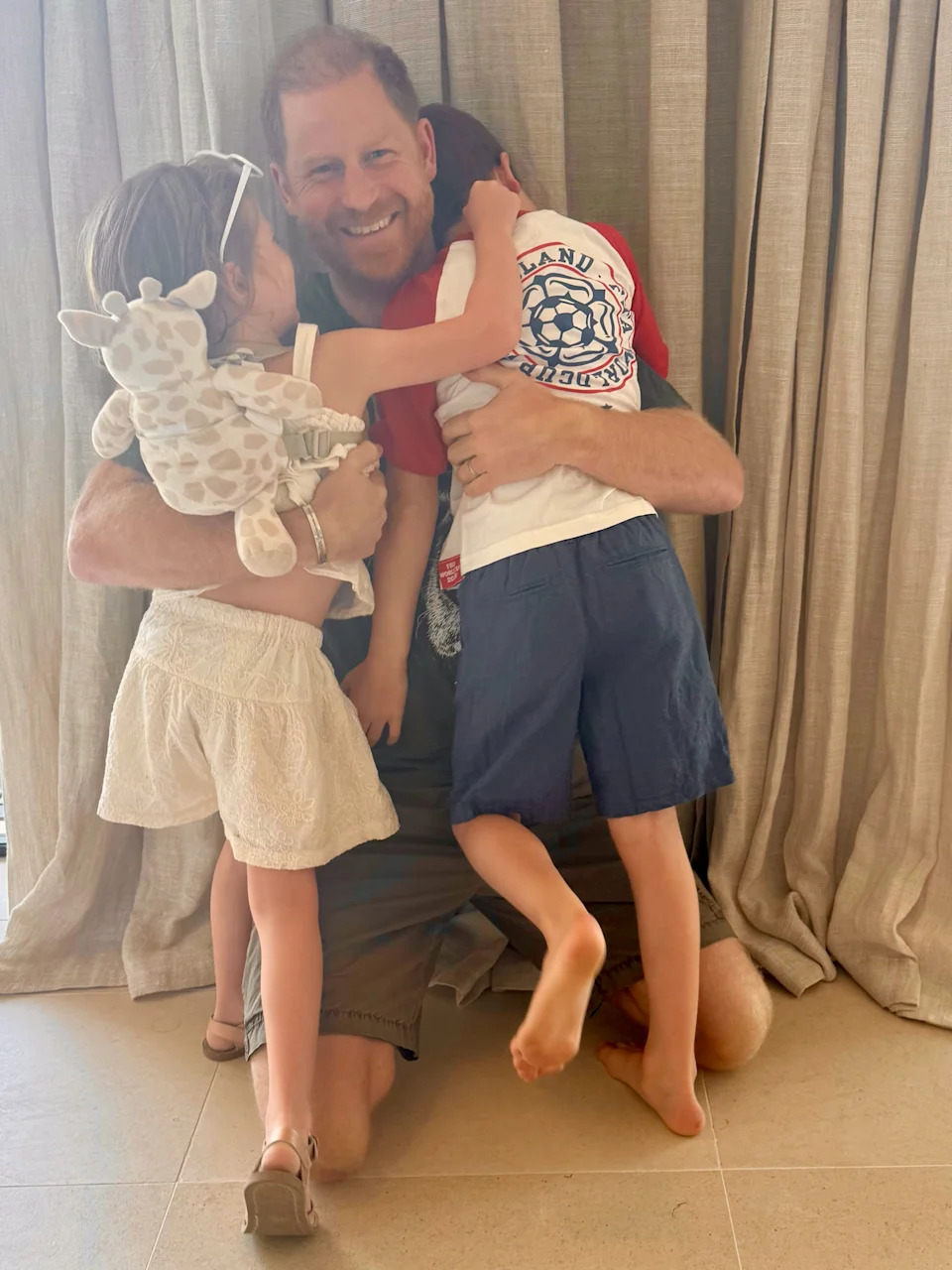 Prince Archie wore an England soccer T-shirt in a photo with his father, Prince Harry, on Father’s Day Sunday. (Seen here: the father-son duo and Princess Lilibet.) Instagram/@meghan