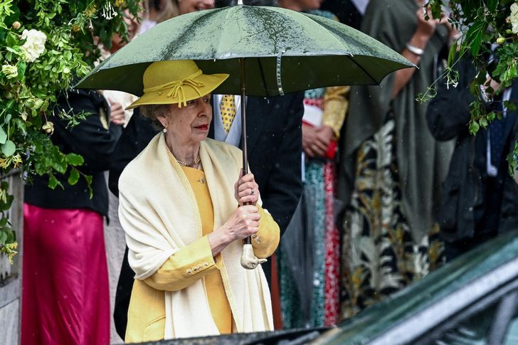 Princess Anne, the younger sister of Britain's King Charles III, holds an umbrella outside All Saints' Church, following the wedding of her son Peter Phillips and Harriet Sperling in Kemble, Cirencester, Britain, Saturday. Reuters-Yonhap