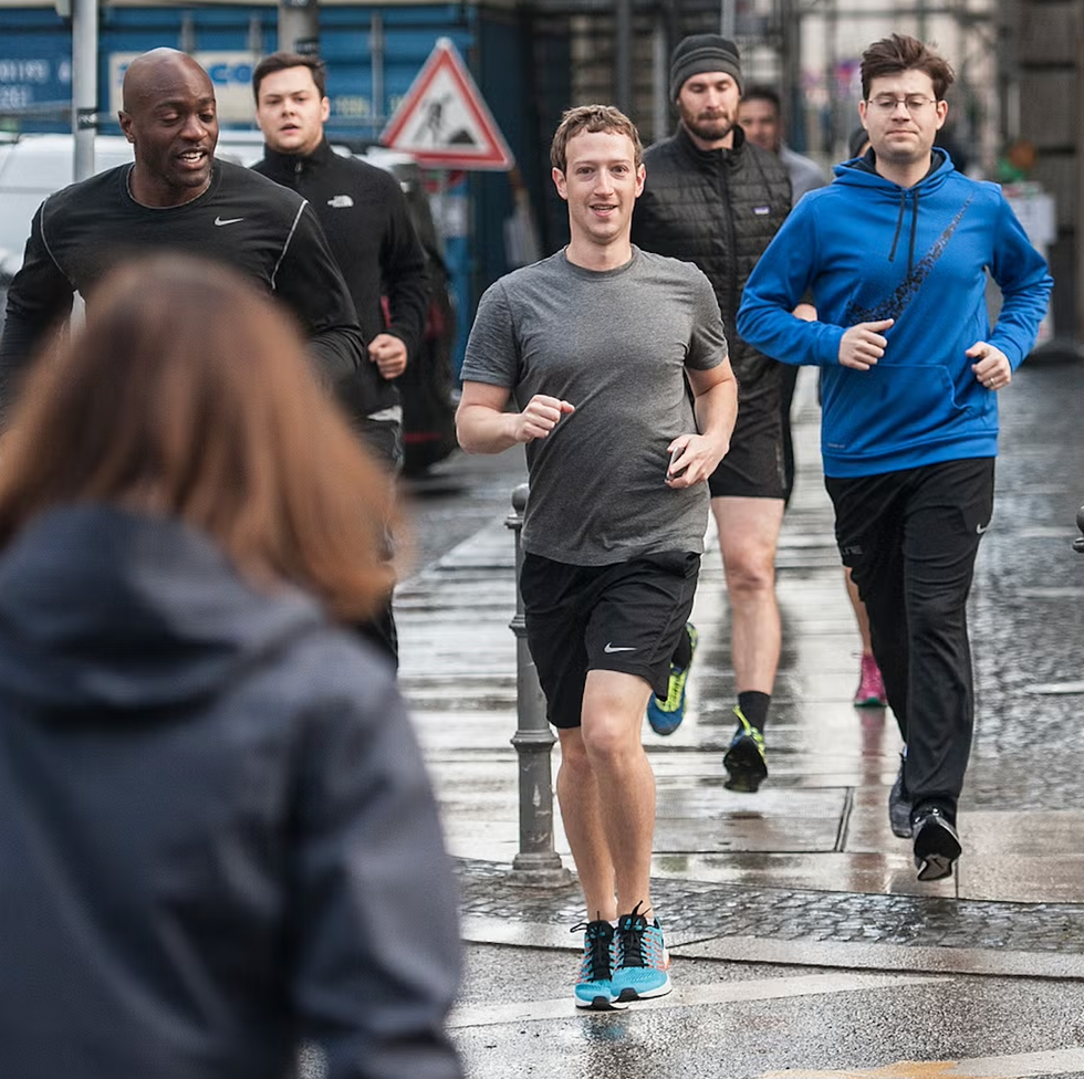 group of runners on a wet urban street group of runners on a wet urban street
