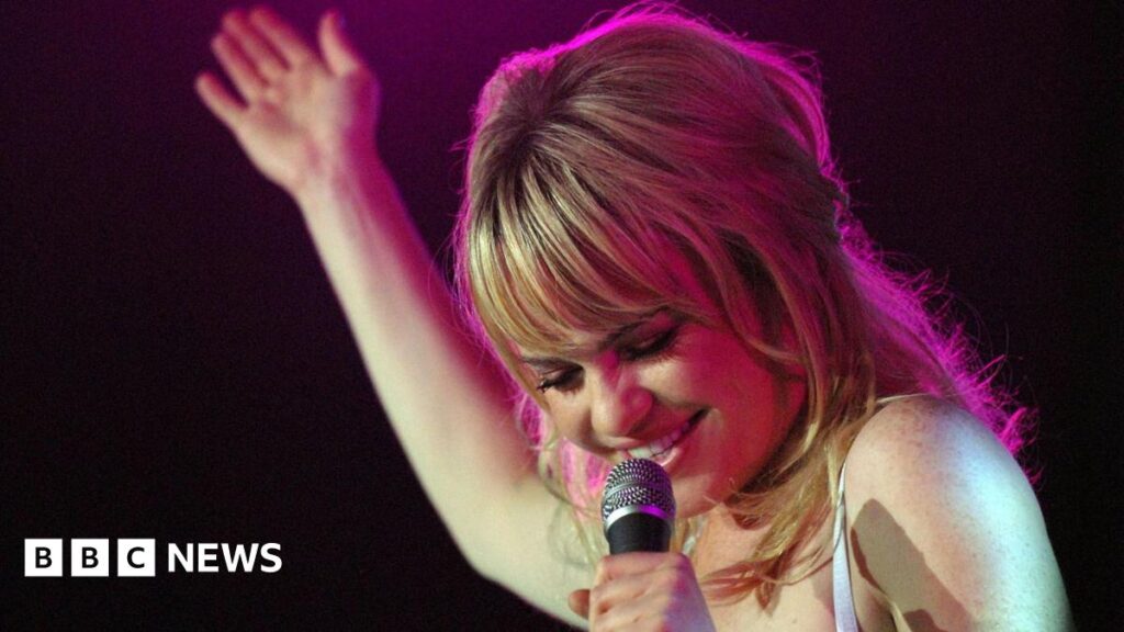 Duffy on stage with a microphone
