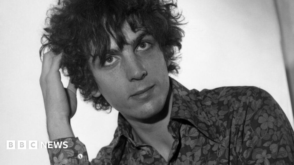 Cambridge concert and album to mark Syd Barrett’s 80th birthday A young girl with brown hair sat in a chair. She's facing a reporter who is holding a mic to her face.