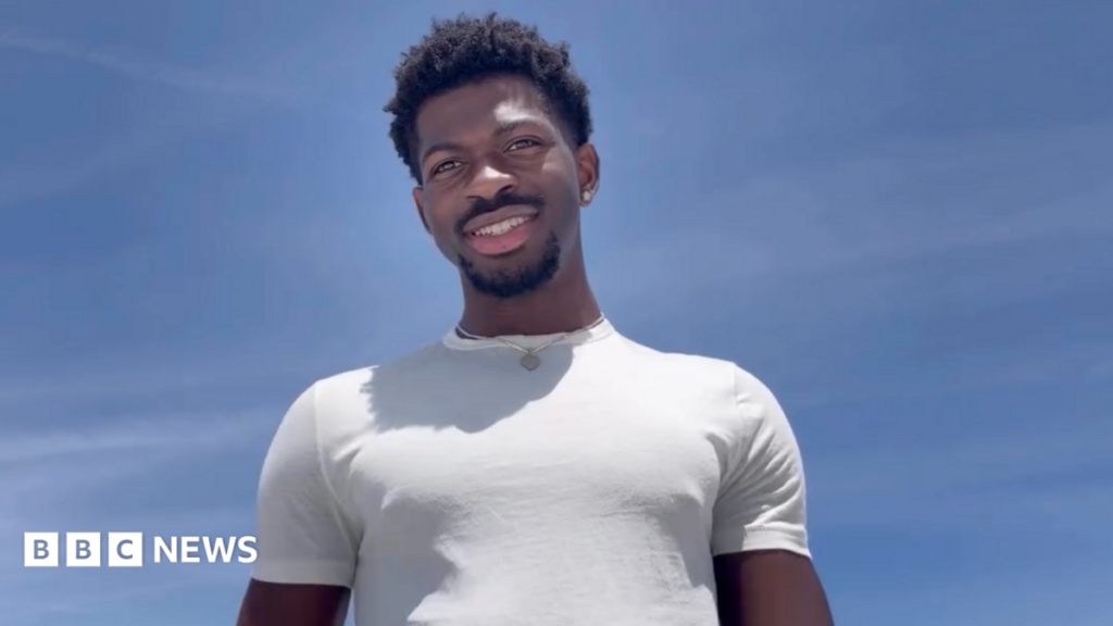 Lil Nas X pictured in a white t-shirt against a clear blue sky, in a screengrab from his Instagram statement