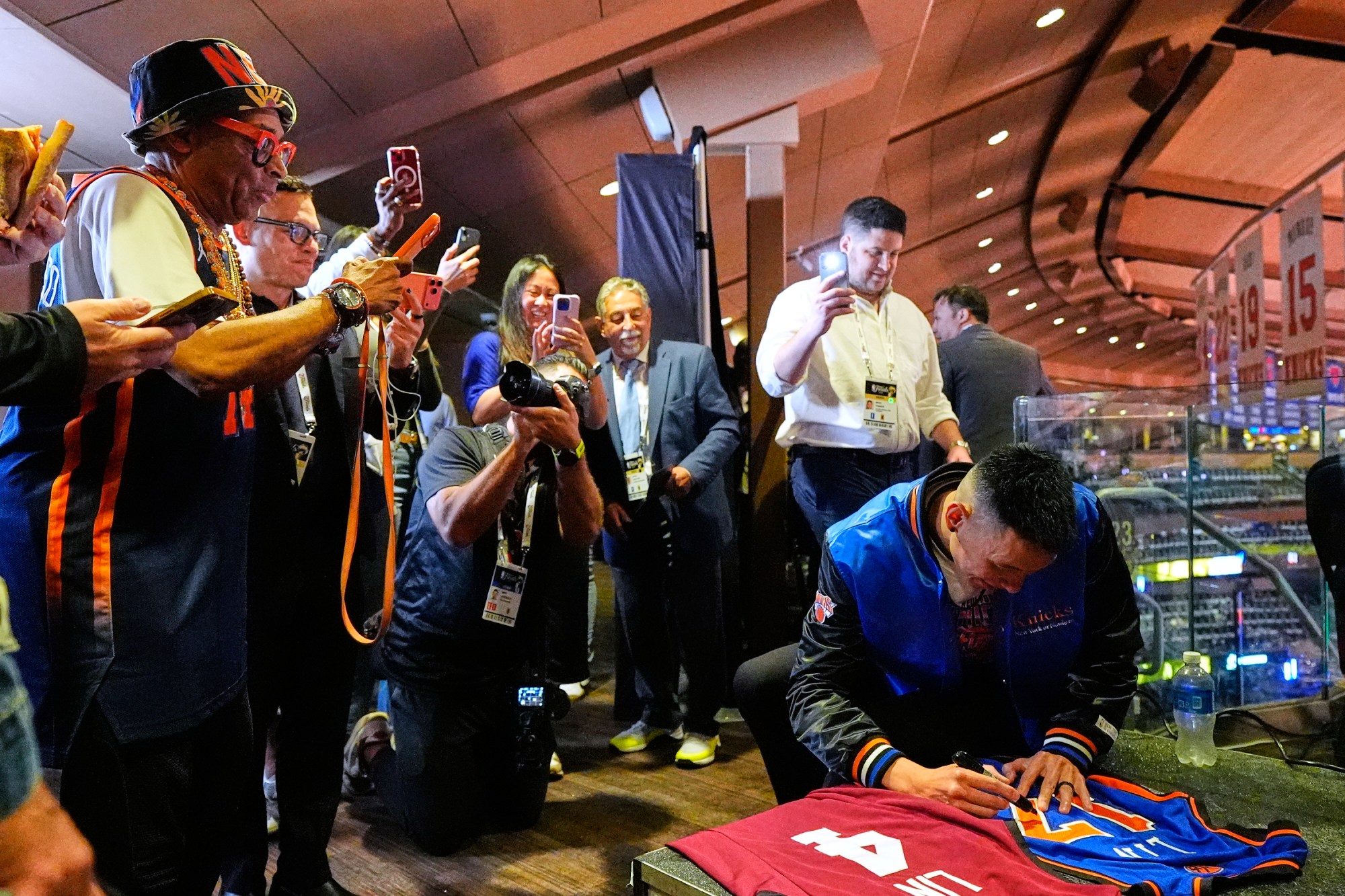 Former NBA player Jeremy Lin signs a jersey prior to Game 3 of the NBA Finals basketball series between the San Antonio Spurs and the New York Knicks, Monday, June 8, 2026, in New York. (AP Photo/Yuki Iwamura)