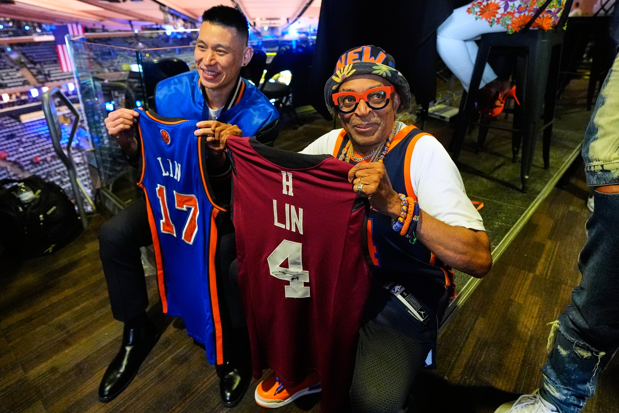 Former NBA player Jeremy Lin, left, and filmmaker Spike Lee hold up jerseys prior to Game 3 of the NBA Finals basketball series between the San Antonio Spurs and the New York Knicks, Monday, June 8, 2026, in New York. (AP Photo/Yuki Iwamura)
